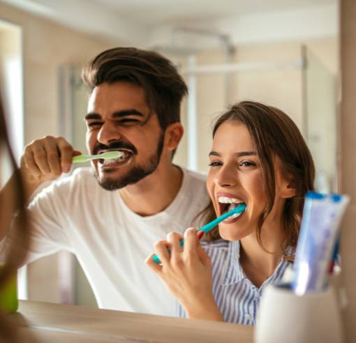 Couple brushing their teeth