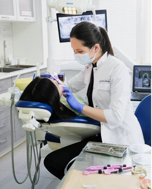Dentist working on her patient teeth
